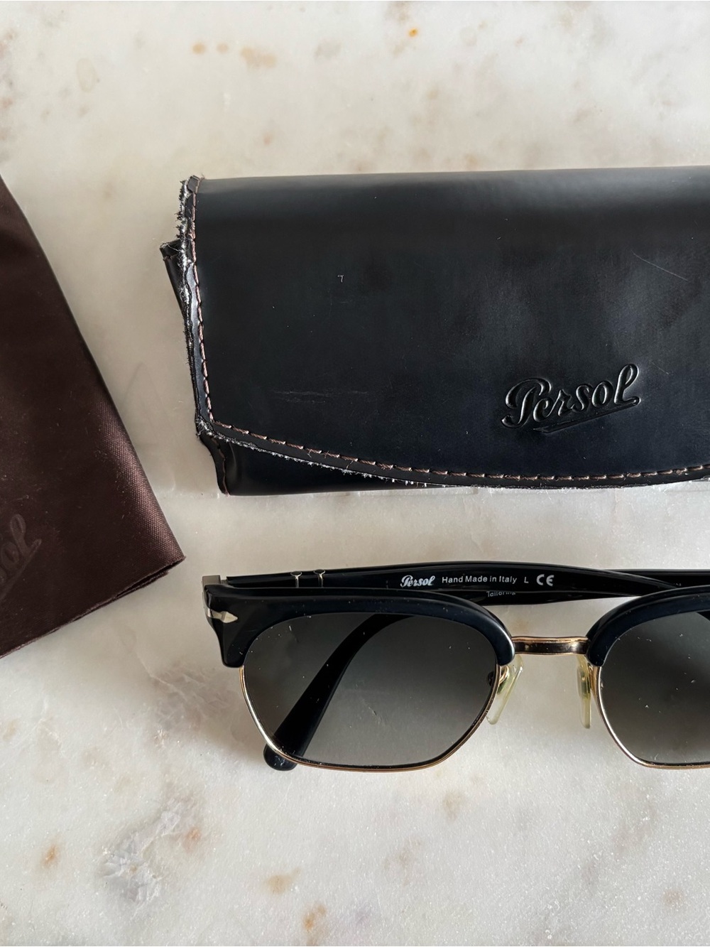 Persol Unisex Black and Gold Sunglasses with Black Leather Case